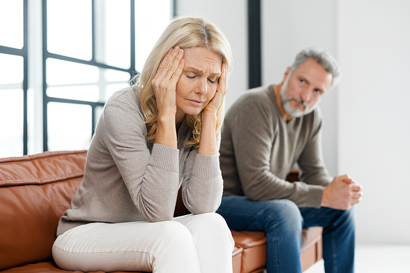 frustrated-senior-couple-at-home-sitting-on-the-couch