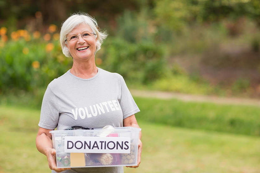 Happy grandmother holding donation box 