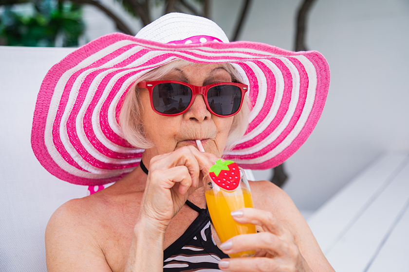 happy-senior-woman-having-party-swimming-pool