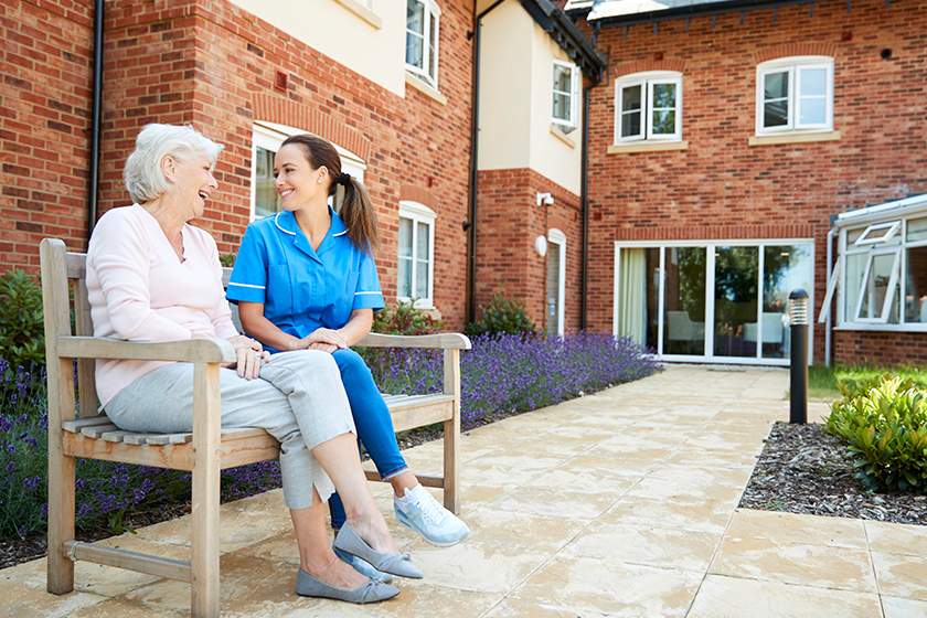 senior-woman-sitting-bench-talking